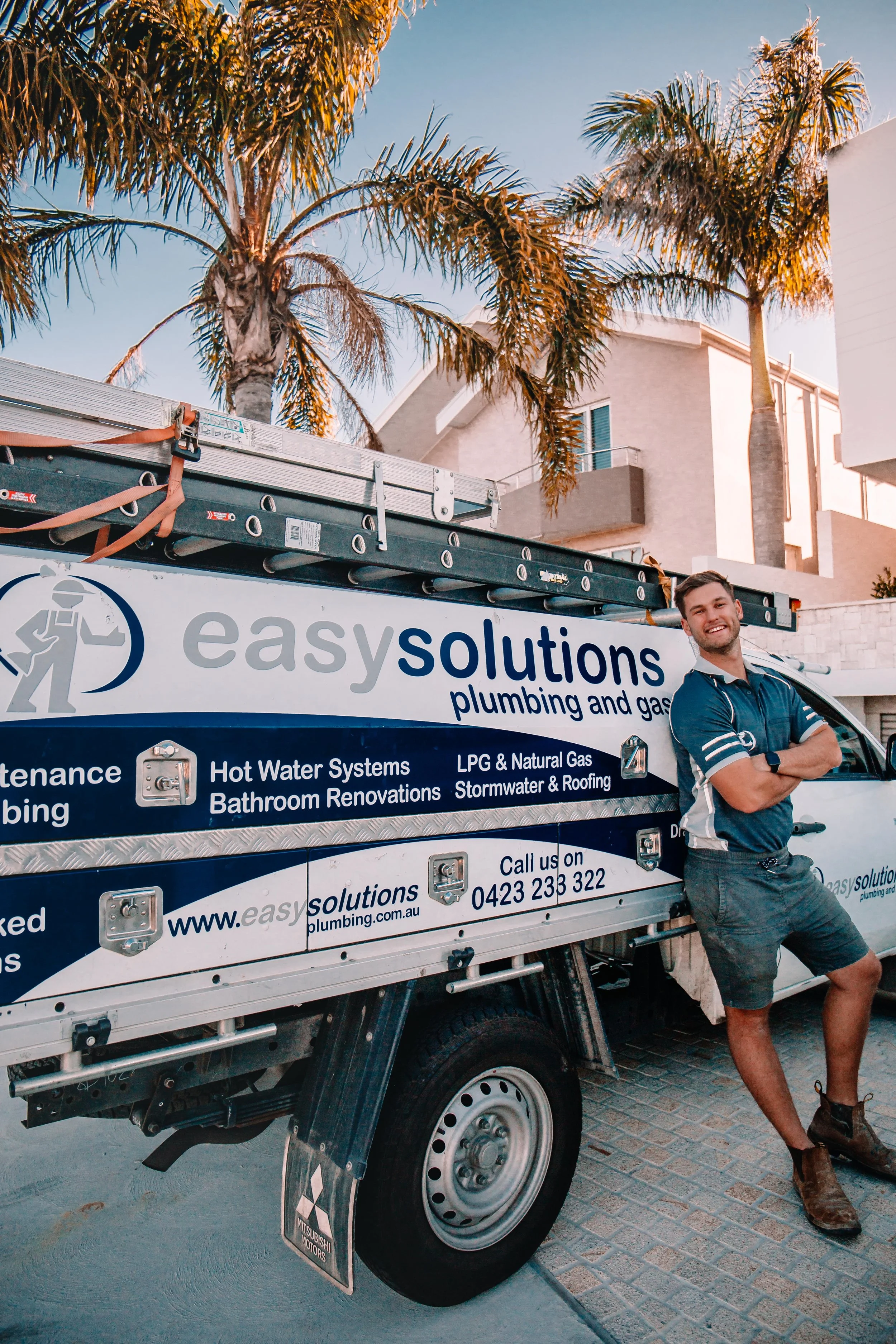 Easy Solutions plumber beside branded service truck in Sutherland Shire