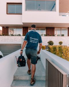 Plumber walking into house